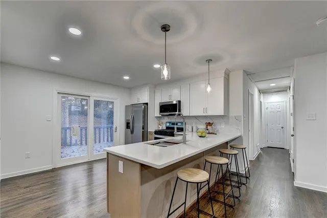 a kitchen with dining table and chairs