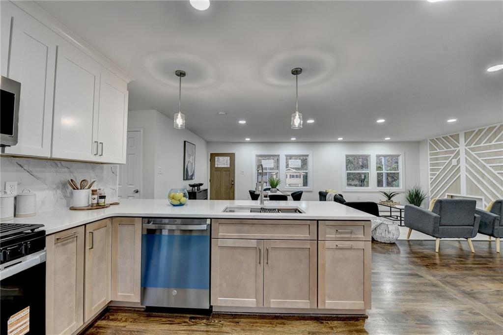 2137 Plantation Lane Chamblee, GA 30341 - Photo 26 of 54 a kitchen with a sink a center island stainless steel appliances and cabinets