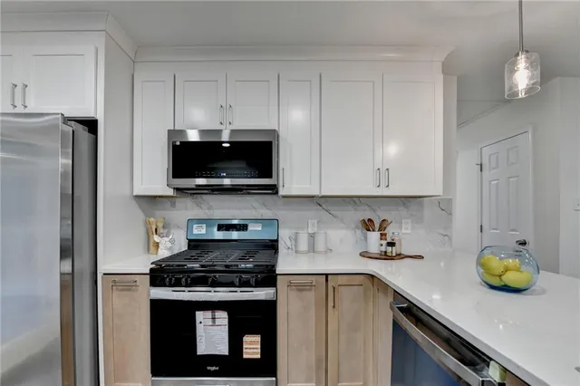 a kitchen with stainless steel appliances a stove sink and refrigerator