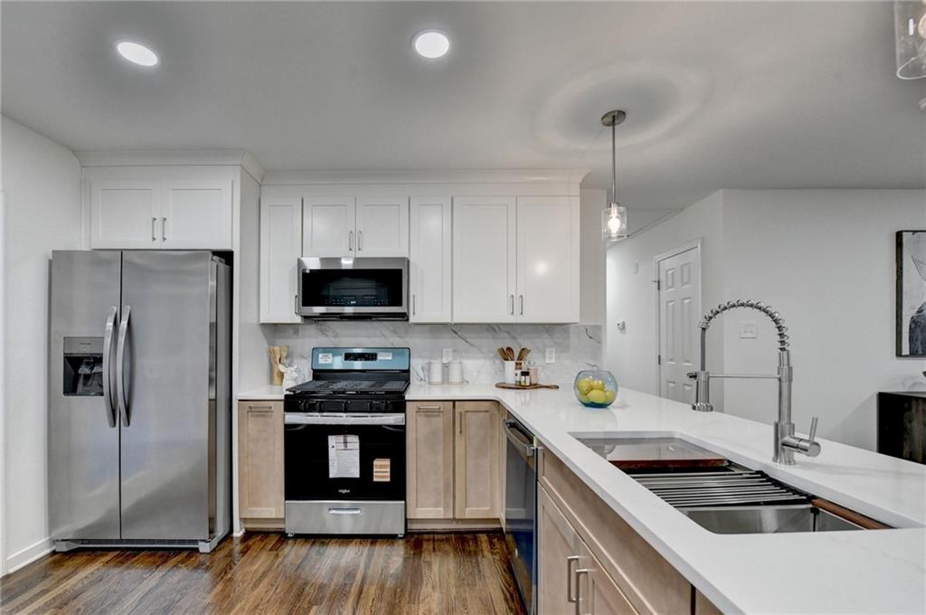 2137 Plantation Lane Chamblee, GA 30341 - Photo 28 of 54 a kitchen with stainless steel appliances a stove sink and refrigerator
