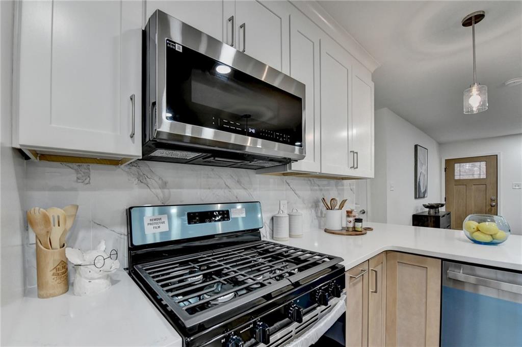 2137 Plantation Lane Chamblee, GA 30341 - Photo 29 of 54 a kitchen with a stove and a microwave