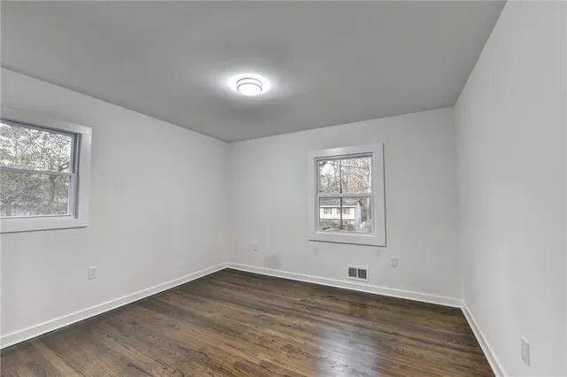 a view of a room with wooden floor and window
