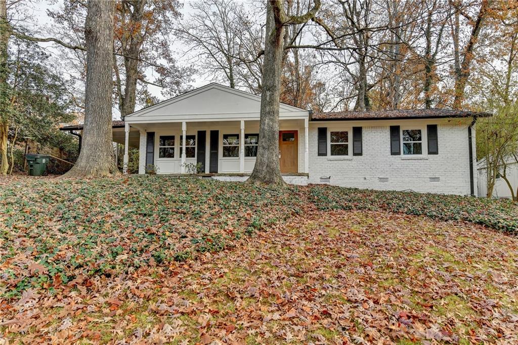 2137 Plantation Lane Chamblee, GA 30341 - Photo 3 of 54 a front view of a house with a garden