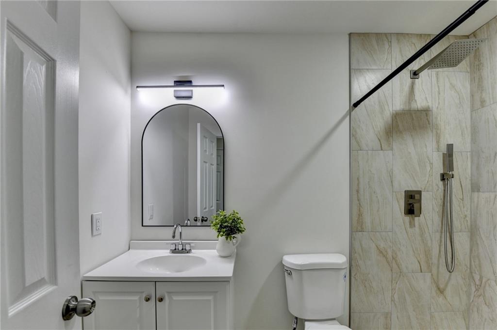 2137 Plantation Lane Chamblee, GA 30341 - Photo 33 of 54 a bathroom with a sink a toilet and shower