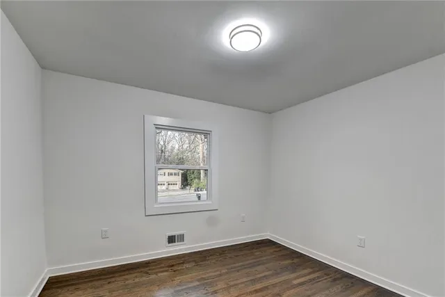 wooden floor in a hall with an empty room