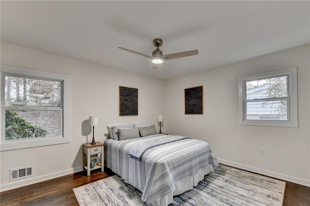 2137 Plantation Lane Chamblee, GA 30341 - Photo 38 of 54 a bedroom with a large bed a chandelier and windows