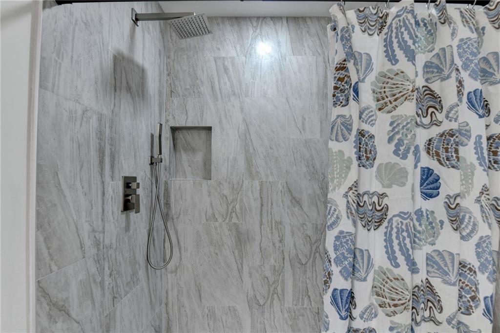 2137 Plantation Lane Chamblee, GA 30341 - Photo 44 of 54 a bathroom with a shower and a shower curtain