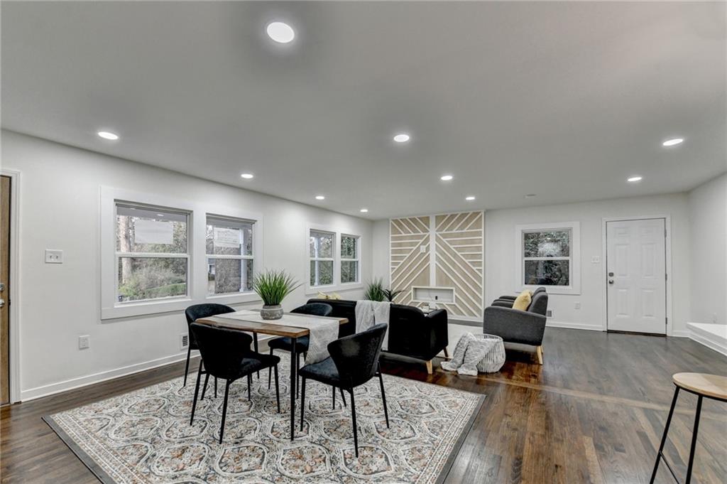 2137 Plantation Lane Chamblee, GA 30341 - Photo 8 of 54 a living room with furniture a large window and wooden floor