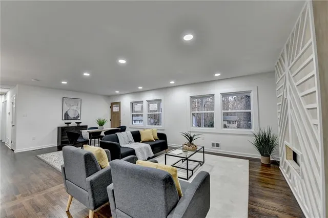 a living room with furniture window and wooden floor