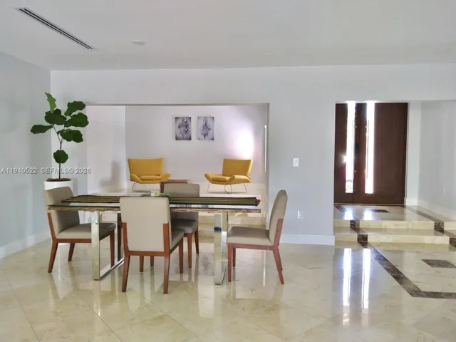 a kitchen with stainless steel appliances granite countertop a sink and a refrigerator