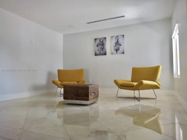 a view of a livingroom with workspace and a window