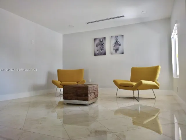 a view of a livingroom with workspace and a window