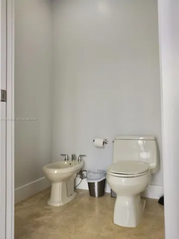 a bathroom with a sink double vanity granite tub shower and a mirror