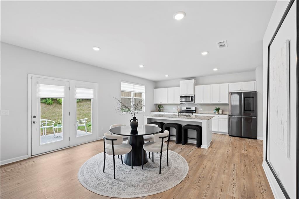 4780 Mock Orange Street Atlanta, GA 30331 - Photo 15 of 47 a view of a kitchen with a dining table and chairs