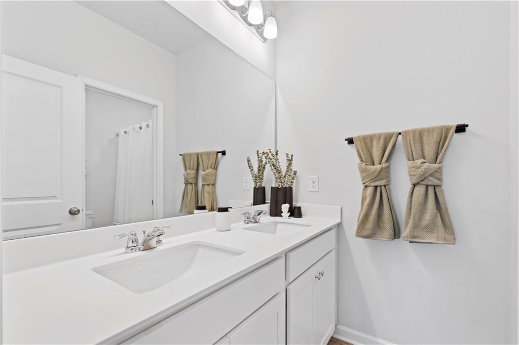 4780 Mock Orange Street Atlanta, GA 30331 - Photo 38 of 47 a bathroom with a double vanity sink and a mirror