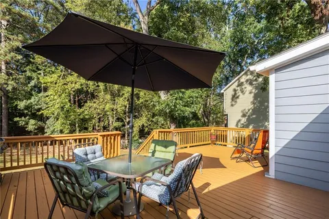a view of balcony with furniture and umbrella