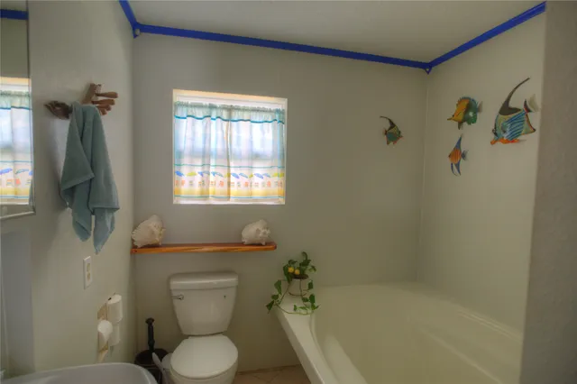 a spacious bedroom with a bed and a view of bathroom