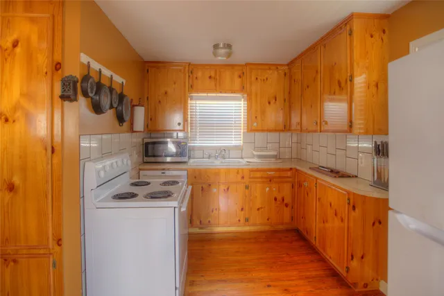 a kitchen with stainless steel appliances a stove a sink and a microwave