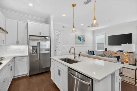 a kitchen with stainless steel appliances granite countertop a sink stove and refrigerator