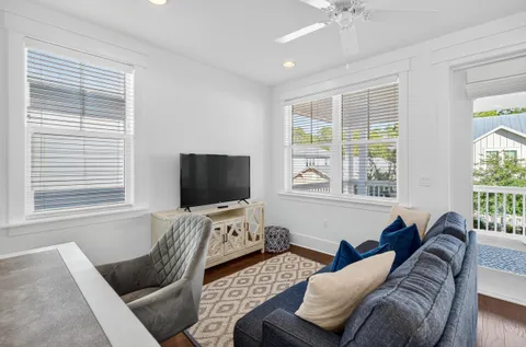 a view of a bedroom with furniture wooden floor and windows