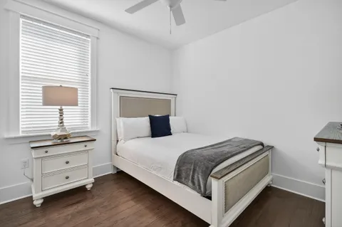 a view of a house with patio furniture and potted plants