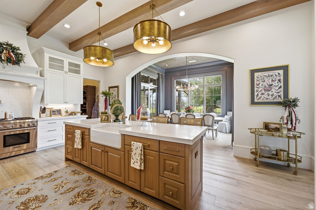 71 Farm Road Midway, UT 84049 - Photo 21 of 92 Gourmet kitchen featuring a wood-finish island with an integrated farmhouse sink, stainless steel range, and white cabinetry