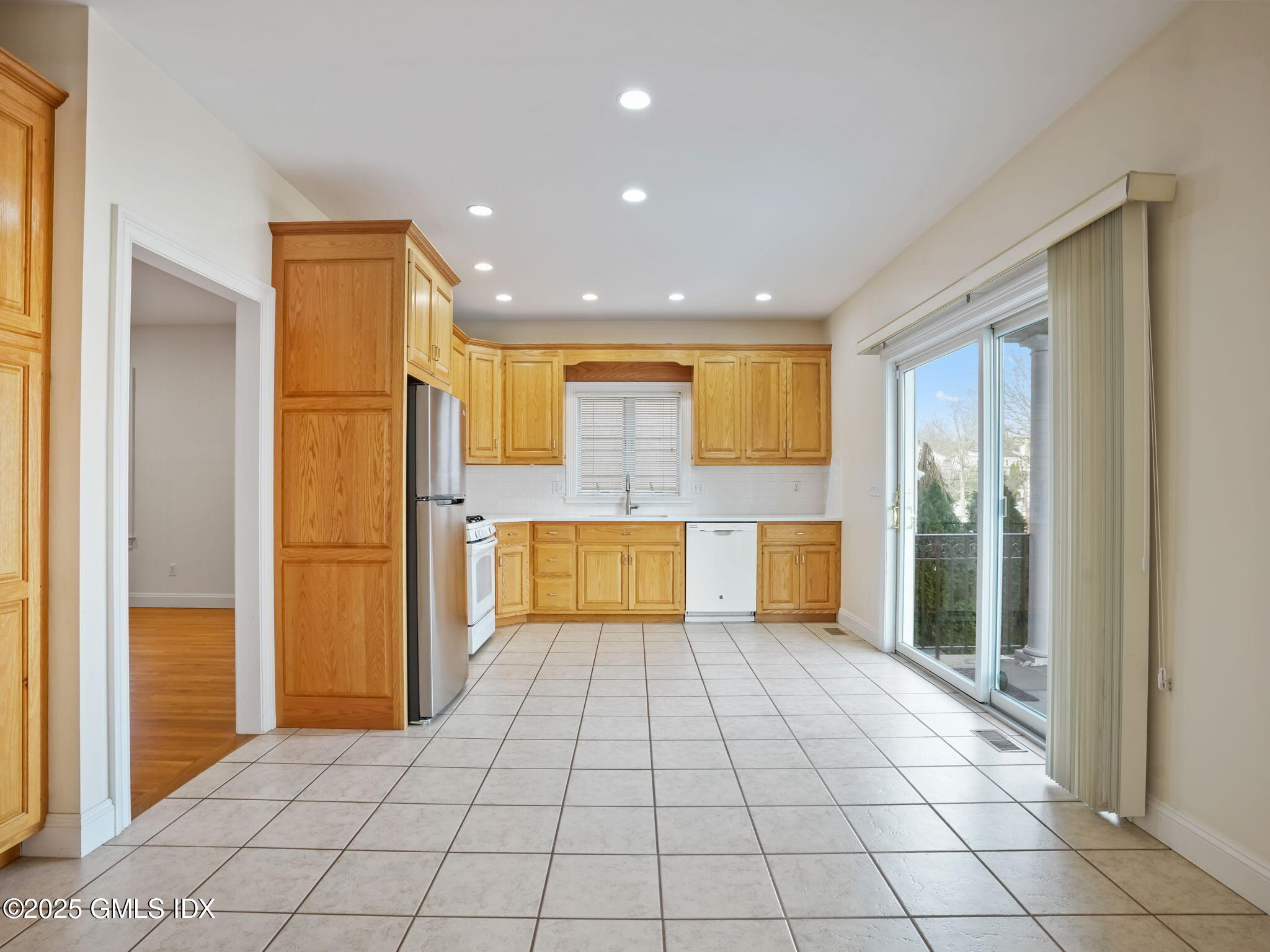 6 Rippowam Road, Unit A Cos Cob, CT 06807 - Photo 9 of 32 a view of a hallway with wooden floor and a living room