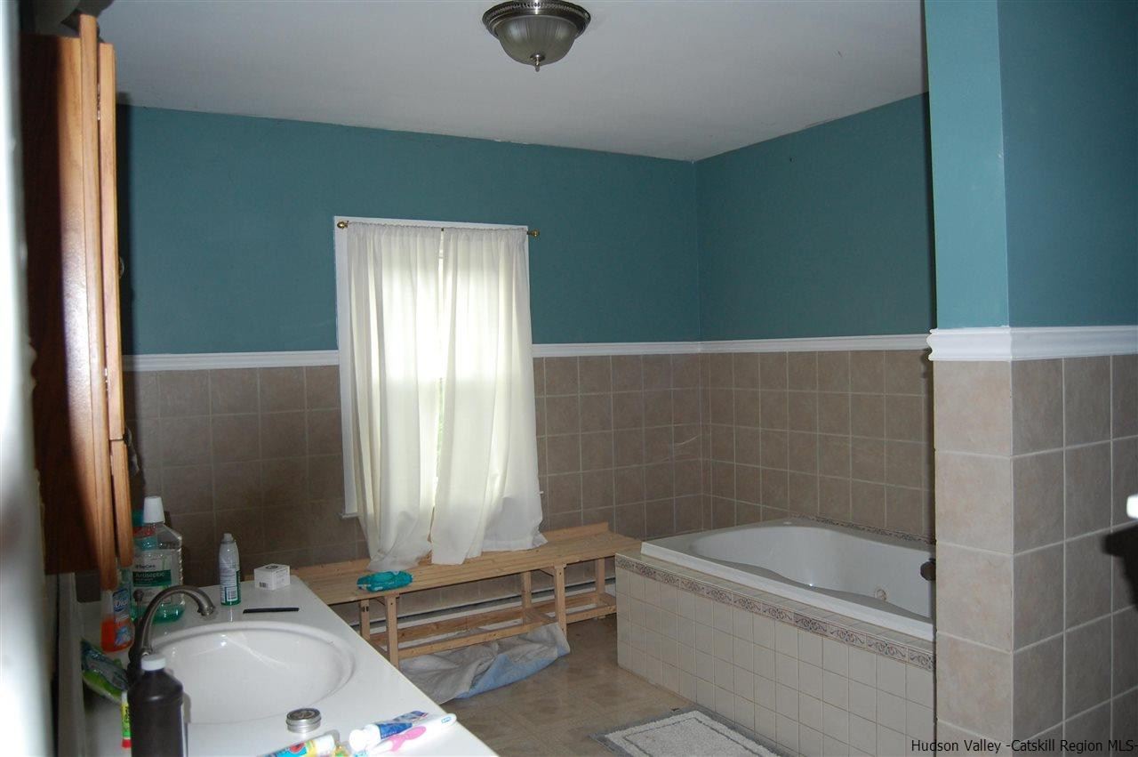 12 Cafaldo Drive Saugerties, NY 12477 - Photo 11 of 17 a bathroom with a tub a sink and a window