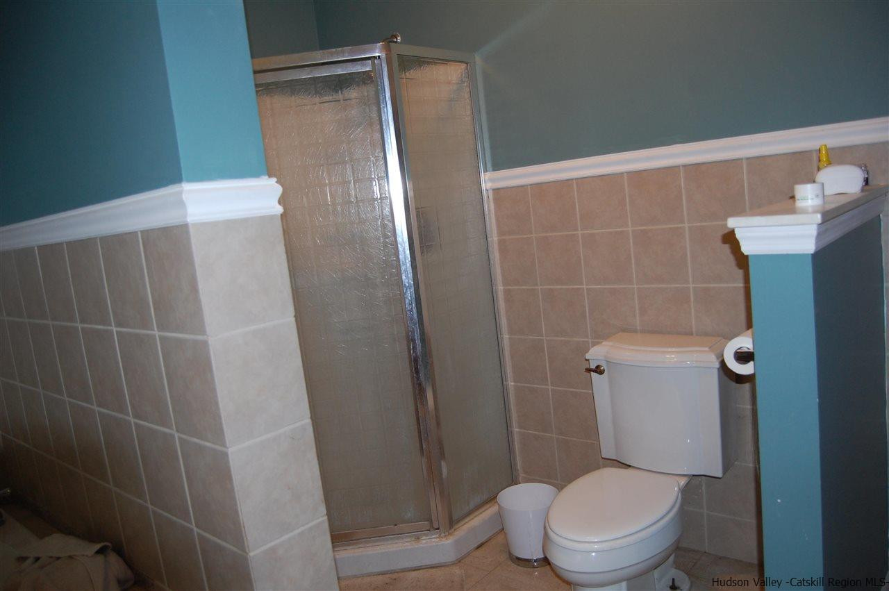 12 Cafaldo Drive Saugerties, NY 12477 - Photo 12 of 17 a white toilet sitting next to a white sink and vanity