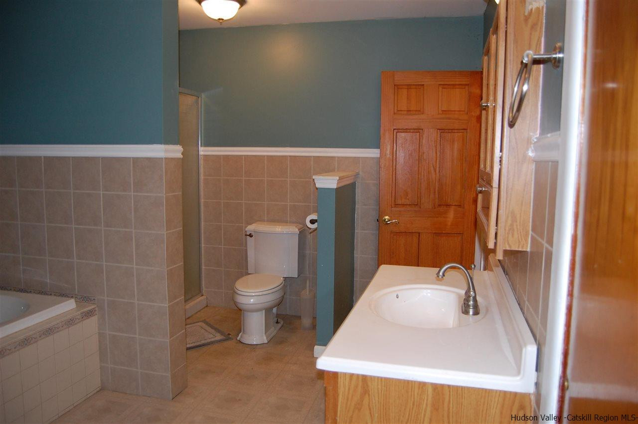 12 Cafaldo Drive Saugerties, NY 12477 - Photo 10 of 17 a bathroom with a sink a toilet and shower
