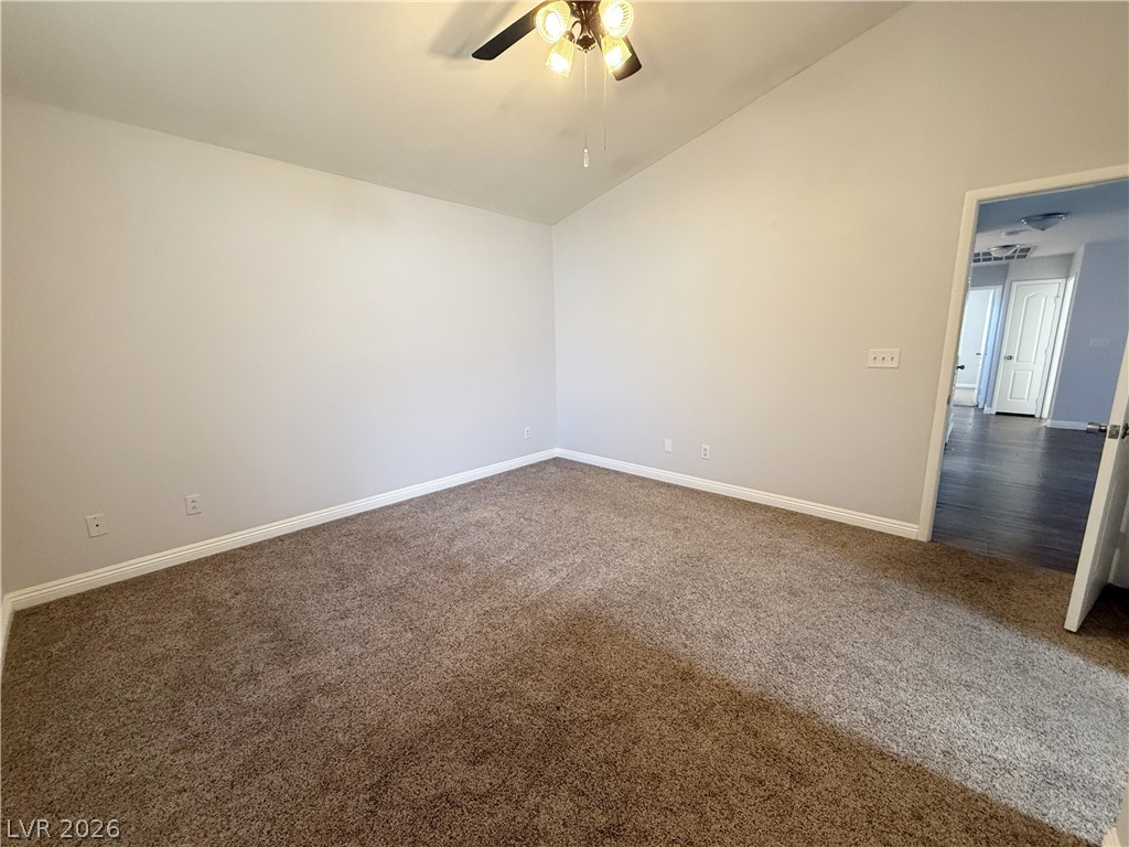 2185 Polynesia Circle Henderson, NV 89074 - Photo 31 of 37 A spacious chamber with soft carpeting provides a serene retreat.