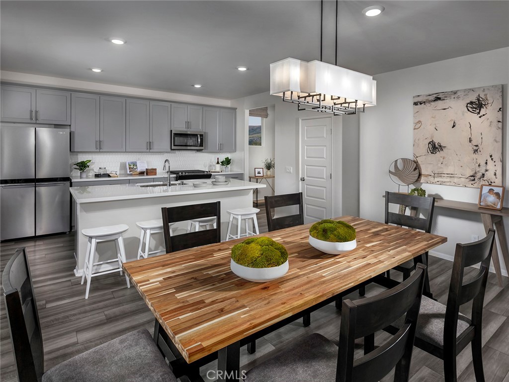 2052 Tangelo Lane Redlands, CA 92374 - Photo 4 of 15 a kitchen with a table chairs and refrigerator