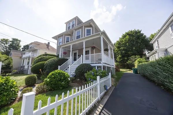 a view of a house with wooden fence