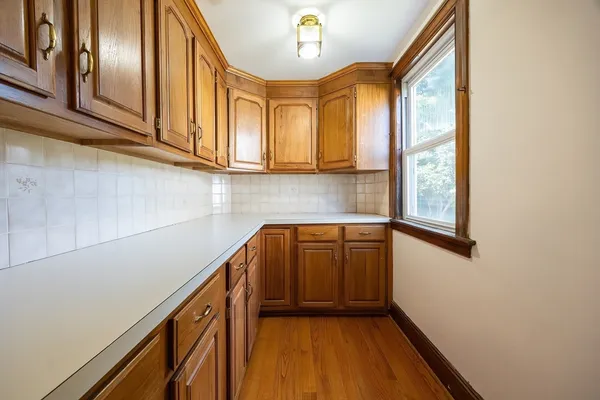 a bathroom with a granite countertop sink a toilet and bathtub