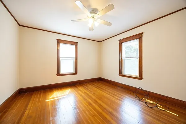 wooden floor in an empty room with a window
