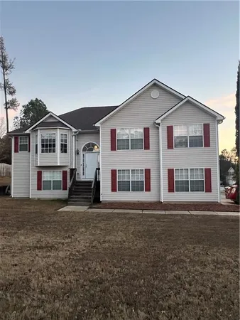 a front view of a house with a garden