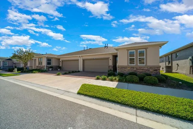 a front view of a house with a yard and a garage
