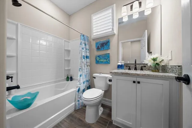 a living room with fireplace furniture and a rug