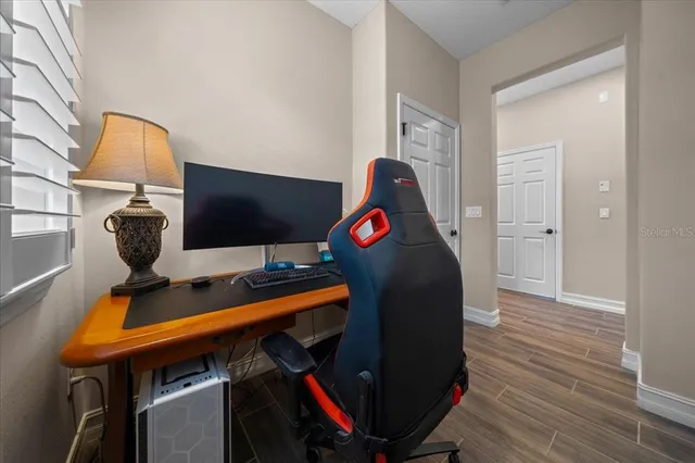a view of a patio with table and chairs with wooden floor and fence