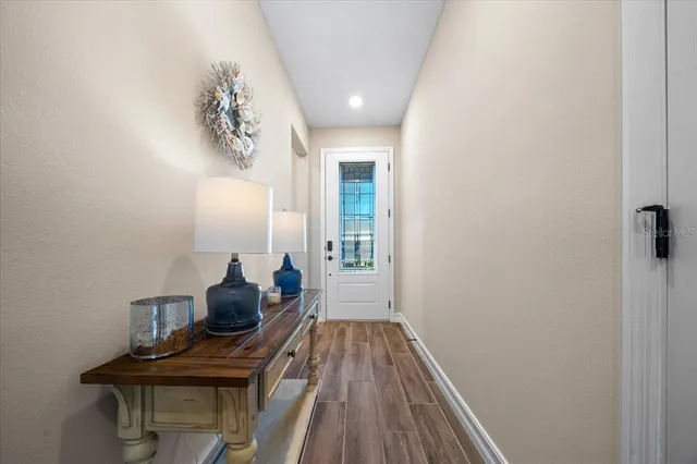 a view of a workspace with furniture and wooden floor