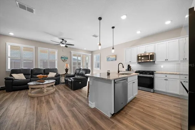 a living room with furniture and wooden floor