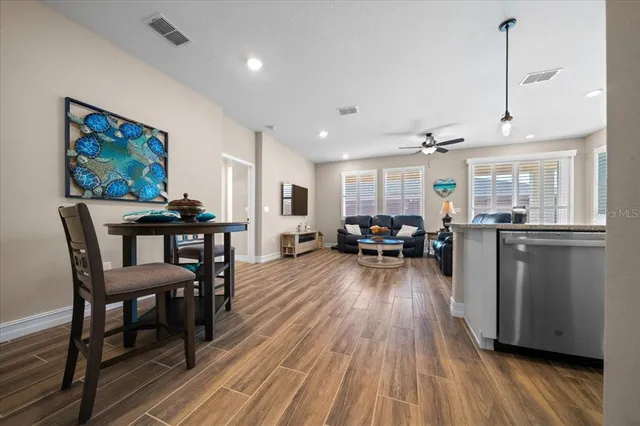 a kitchen with kitchen island granite countertop a sink appliances cabinets and a counter top space