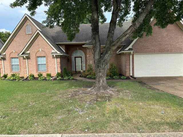 a front view of house with yard and green space