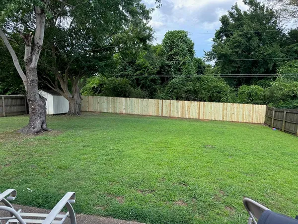 a view of a backyard with a small cabin