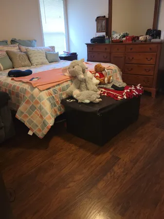 a bed sitting in a bedroom next to a window
