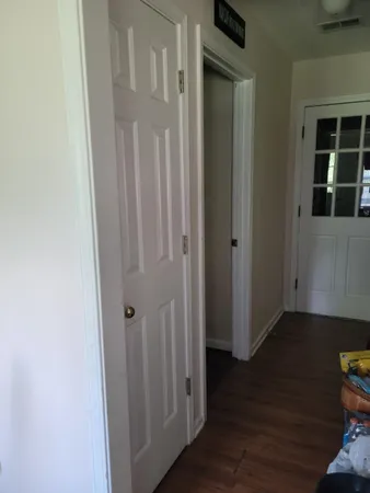 a view of a hallway with wooden floor