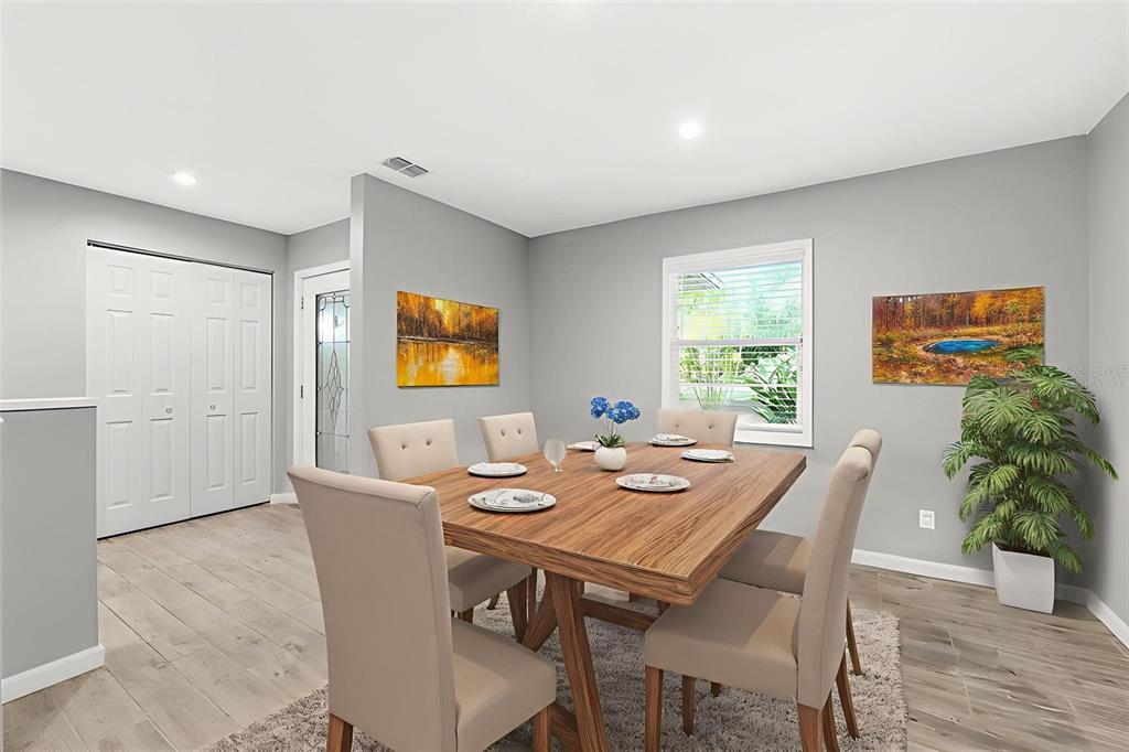 12210 State Street Tampa, FL 33635 - Photo 11 of 41 a view of a dining room with furniture and wooden floor