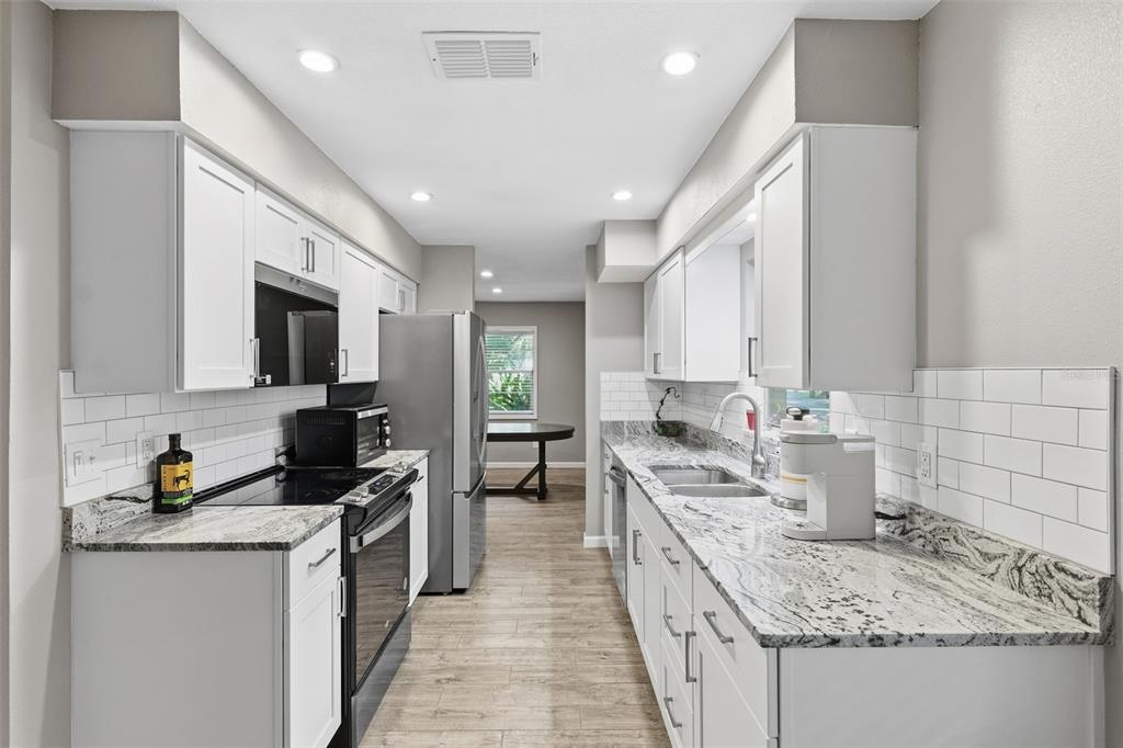 12210 State Street Tampa, FL 33635 - Photo 12 of 41 a kitchen with a sink stove and cabinets