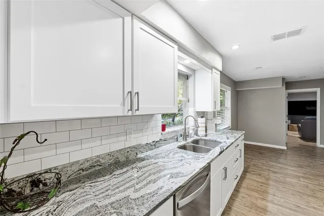 a kitchen with a sink stove and cabinets