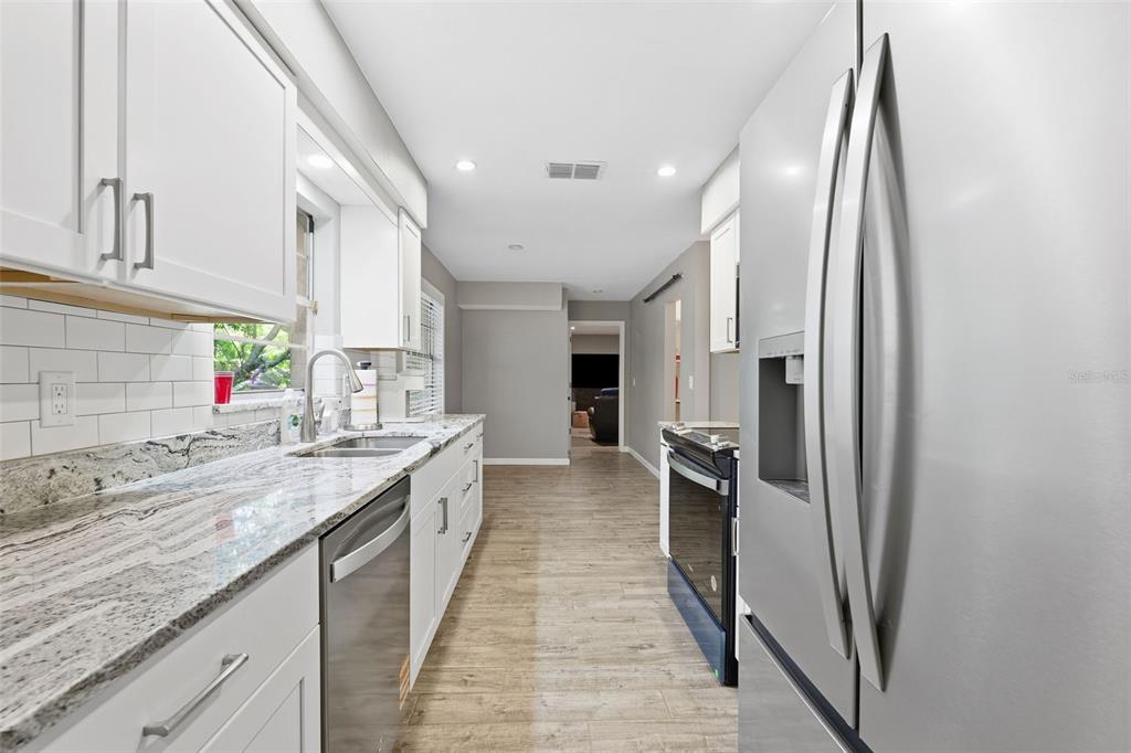 12210 State Street Tampa, FL 33635 - Photo 15 of 41 a large kitchen with stainless steel appliances granite countertop a refrigerator and a sink